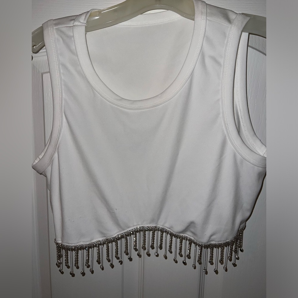 White crop tank top. Bottom lined with rhinestone fringe. Never worn before.